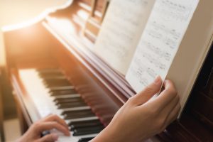 Musician,Playing,Piano,In,Church,With,Vintage,Filter.