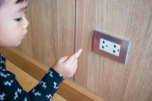 A,Child,Is,Trying,To,Poke,Into,Electrical,Outlets.,Kid